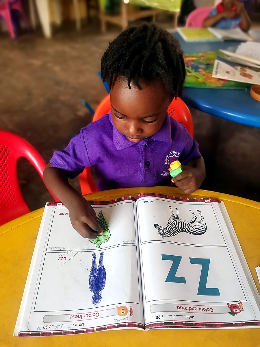 A pupil reading a workbook in class